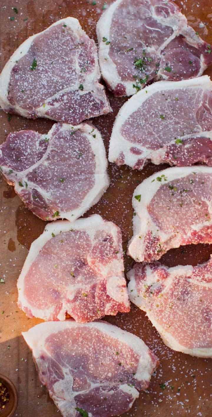 Raw pork chops on a board